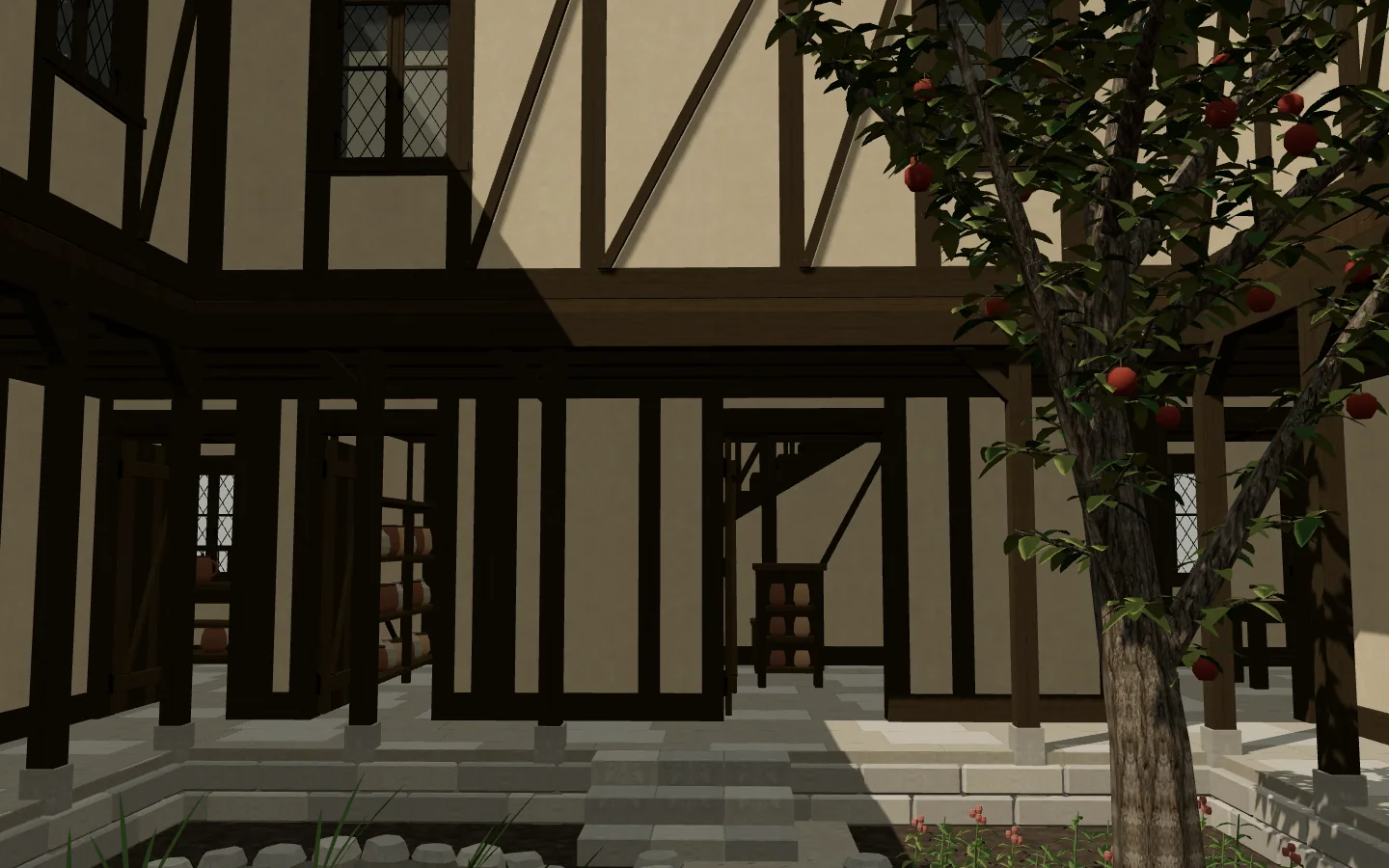 The courtyard garden with its pond, apple tree, and benches between the two wings.